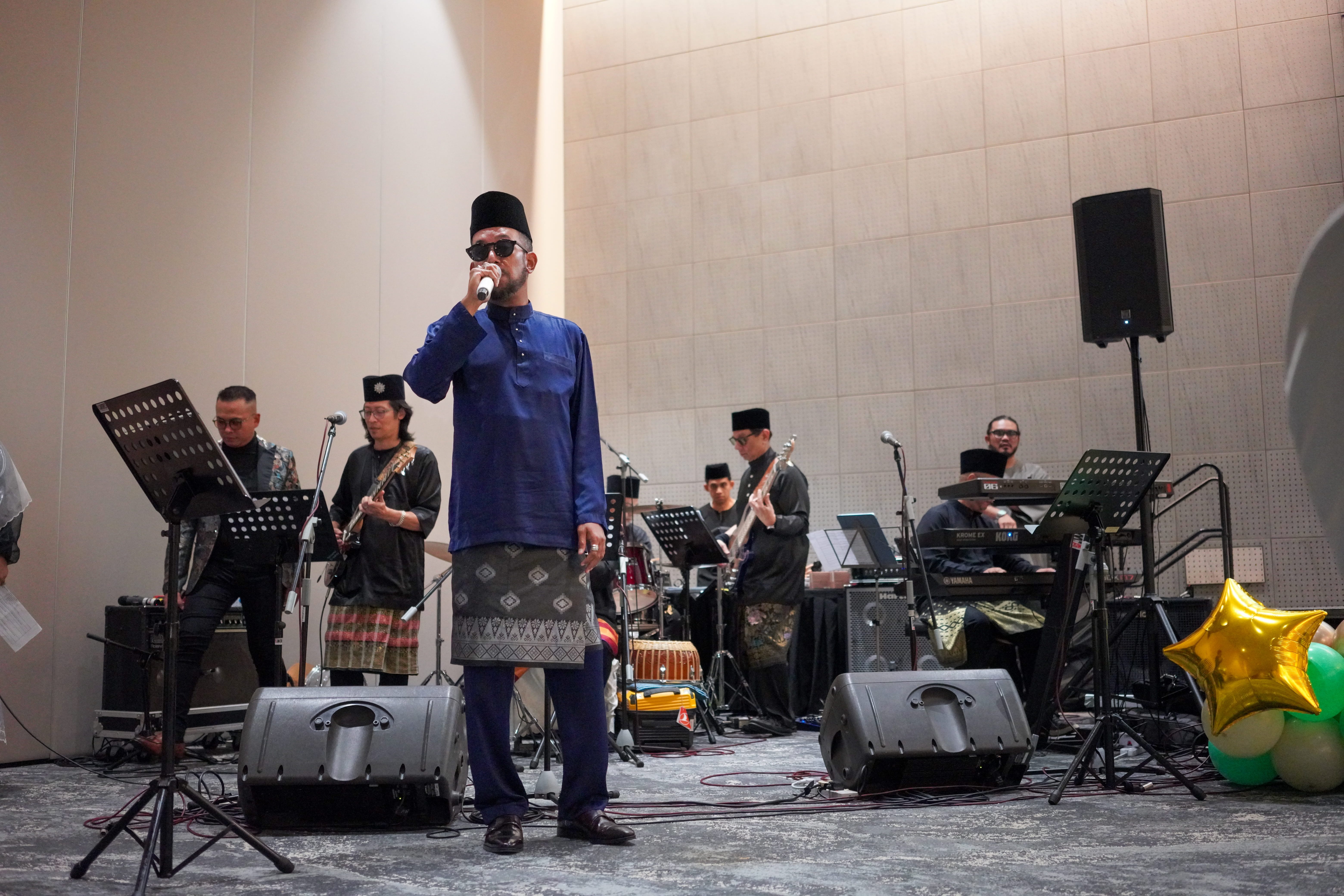 A singer performing with a live band.